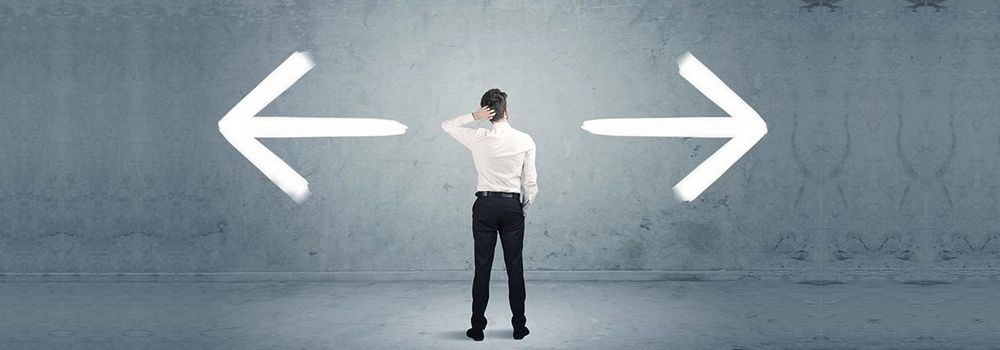 criar-site-para-transportadora-dois-caminhos Criar sites de transportadoras de cargas: na imagem, homem em dúvida sobre duas possibilidades de caminhos: site gratuito ou pago