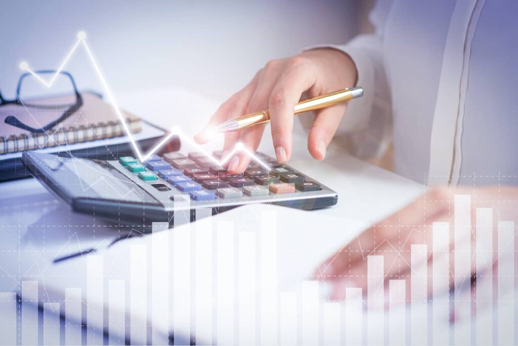 Como vender mais fretes? Na imagem, vemos pessoas com lápis e calculadora na mão, o que representa a possibilidade de lucrar mais com fretes