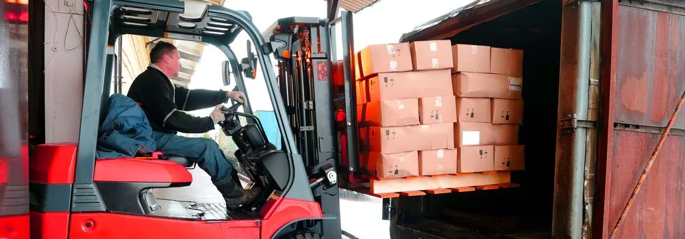 Como usar o Just in Time? Na imagem, trabalhador organizando caixa de mercadorias para entrega